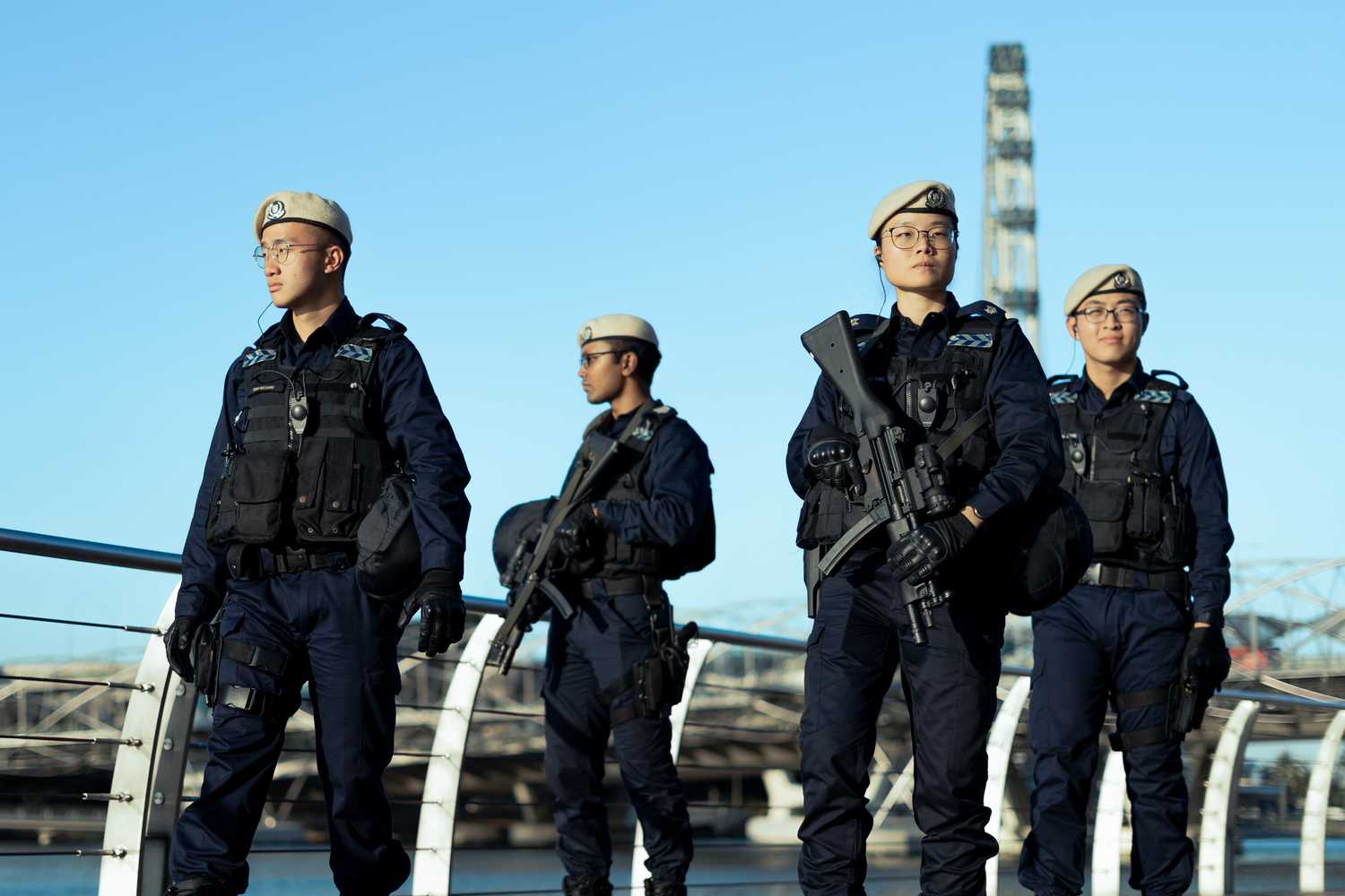 ASP Tan in patrol with her IRT team, with the Singapore flyer in the background