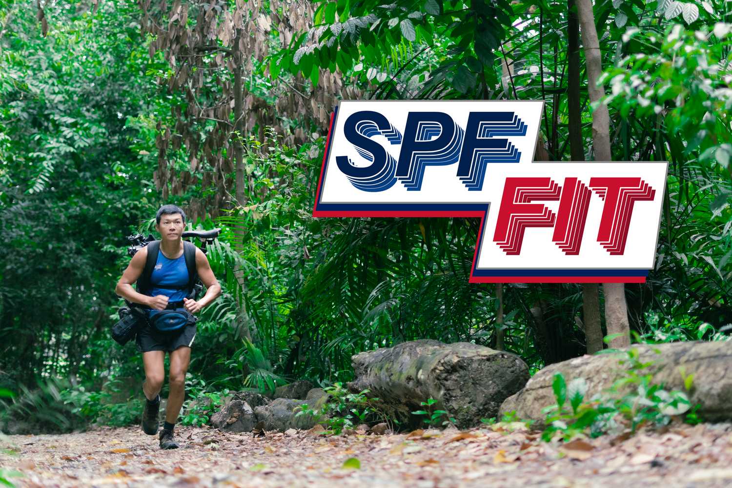 SI Lim running along a trail surrounded by green trees.