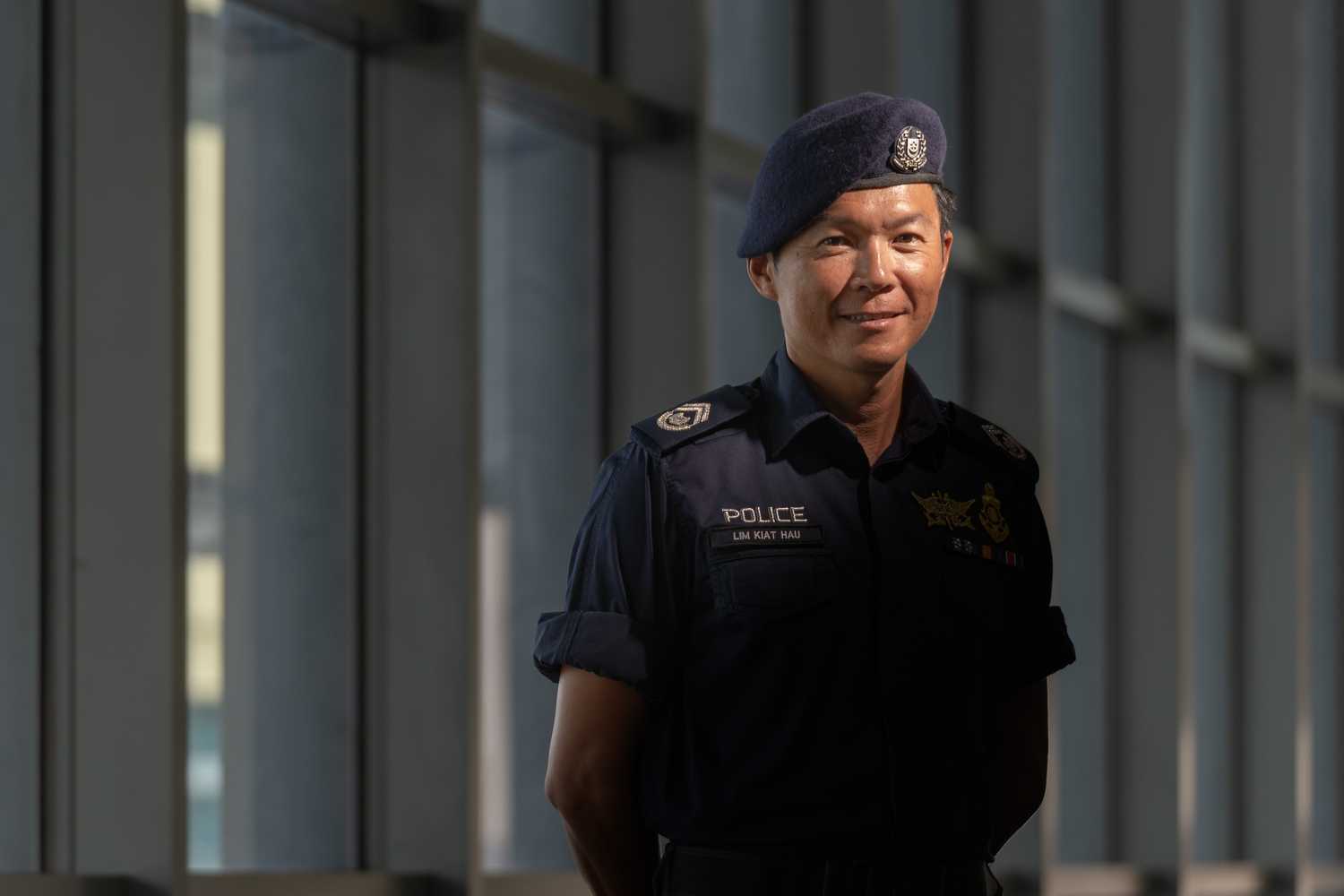 SI Lim in his police uniform posing for the camera. 