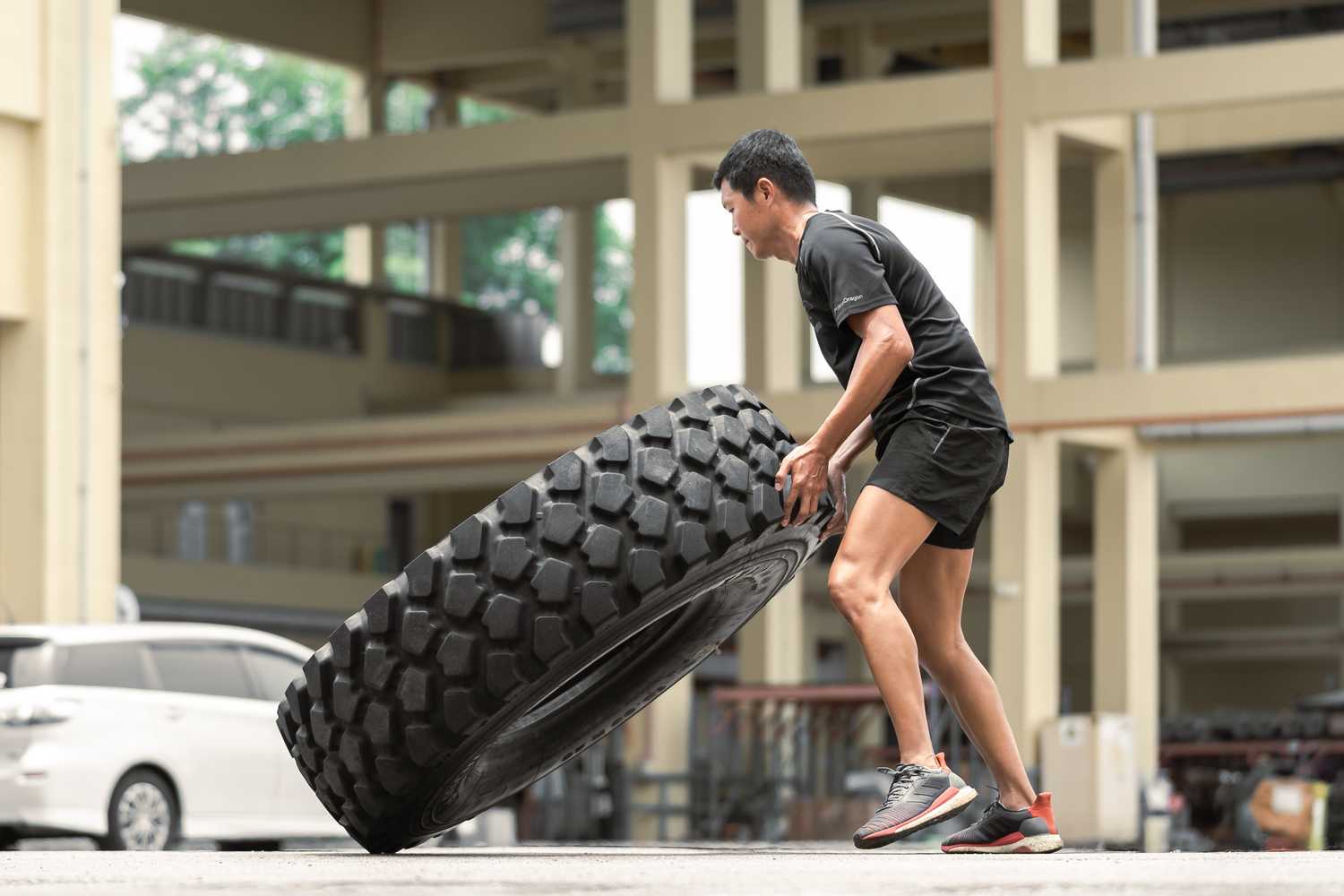 SI Lim flipping a big tire.