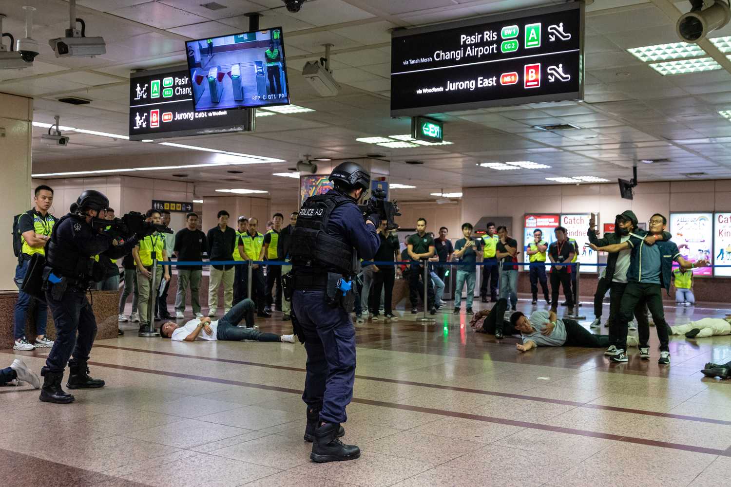 transcom officers with their guns pointed at a subject holding onto a hostage