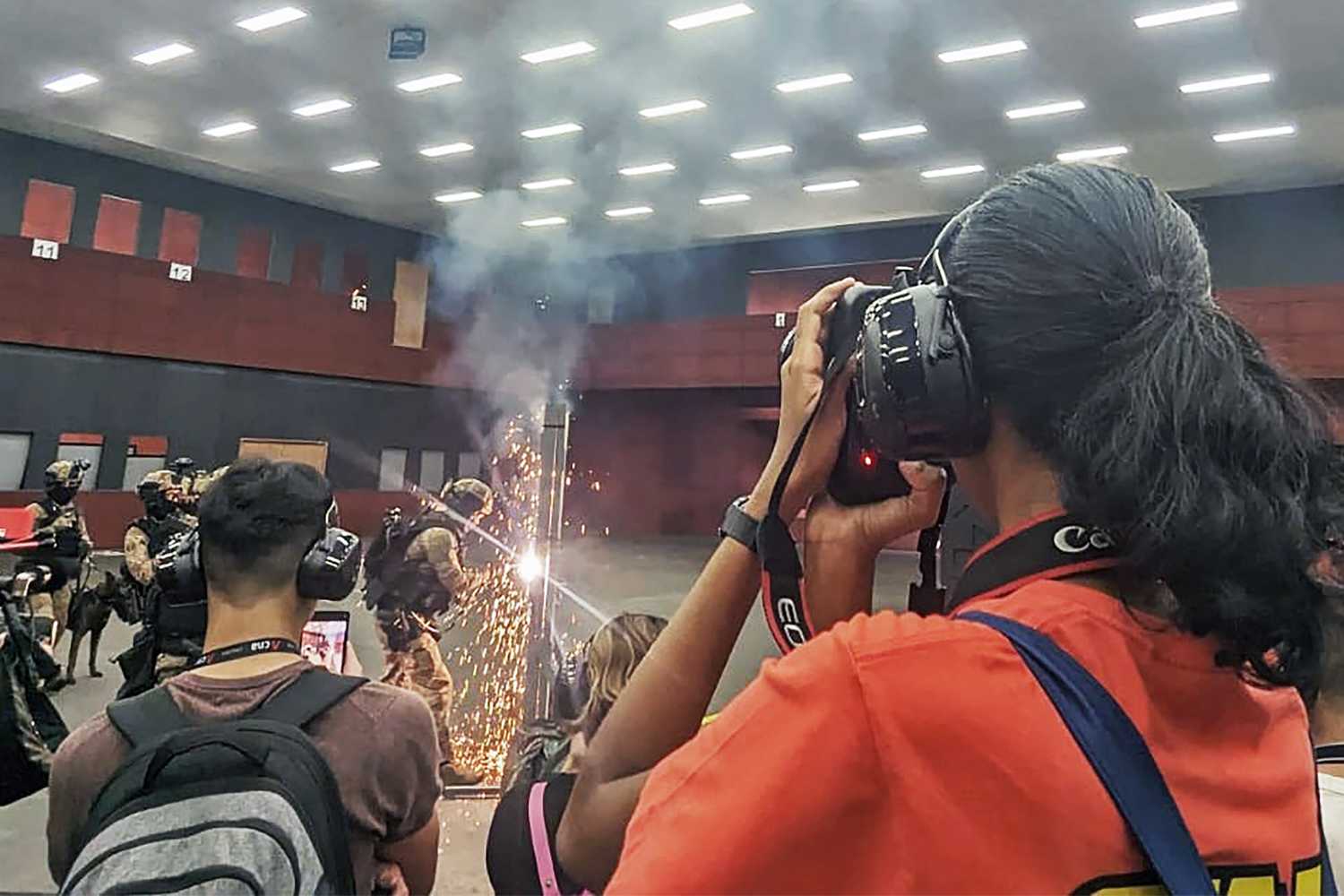 ashwini taking a photograph using a camera of officers doing a forced entry 
