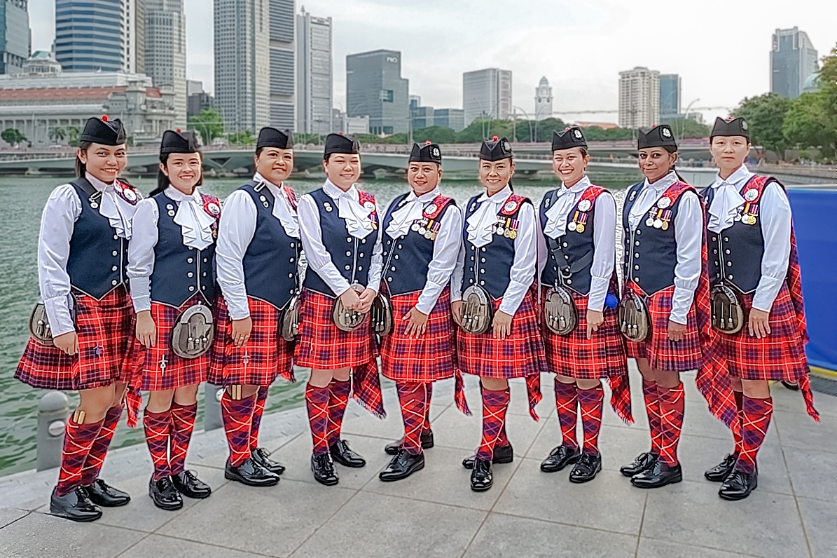SI Julizah Binti Kassim standing in the middle of a group picture of 9 WPPD members posing and standing in a line. They took this photo after a Mother’s Day performance at the Esplanade in May 2023.