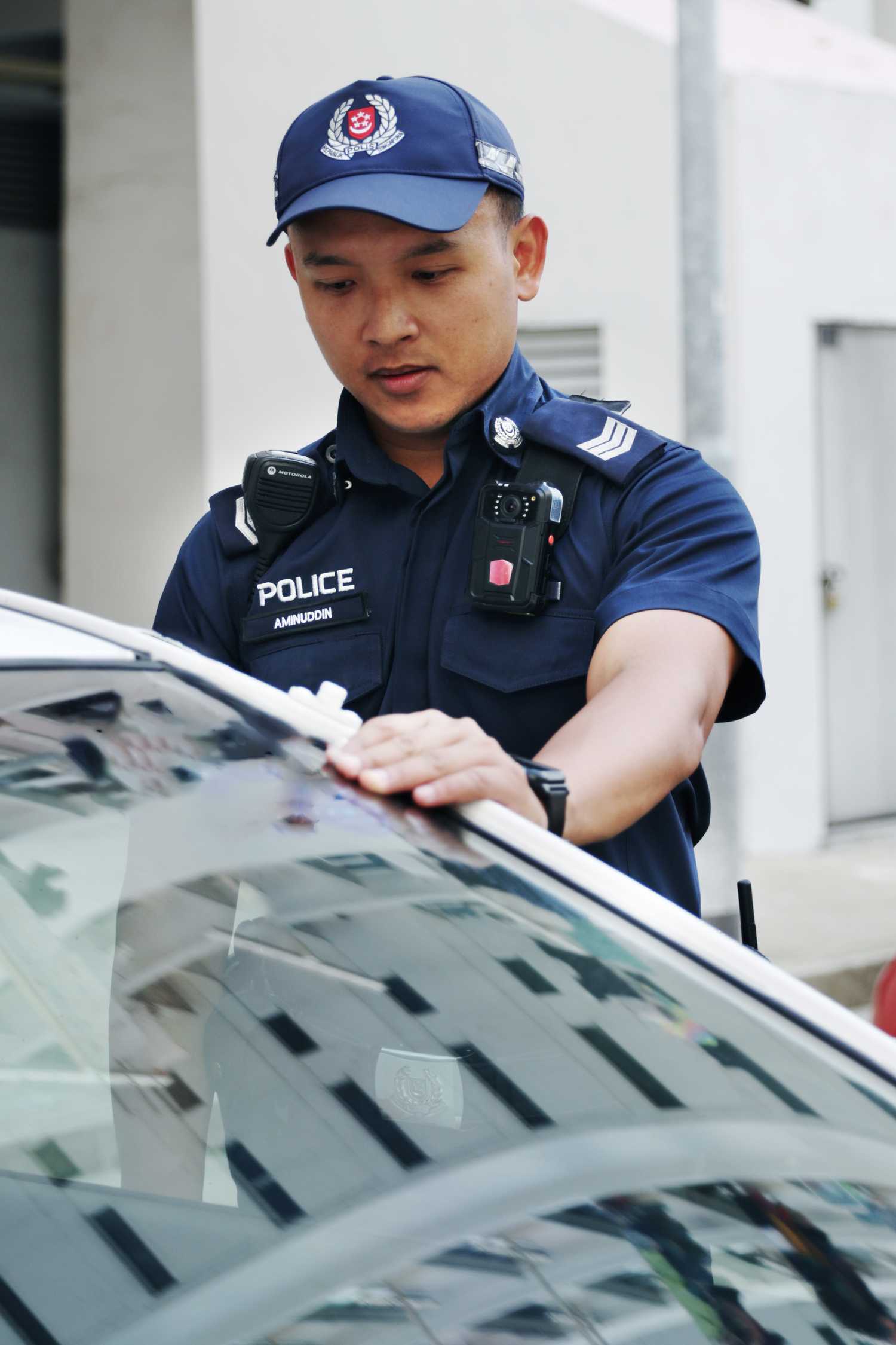 officer getting into a police car