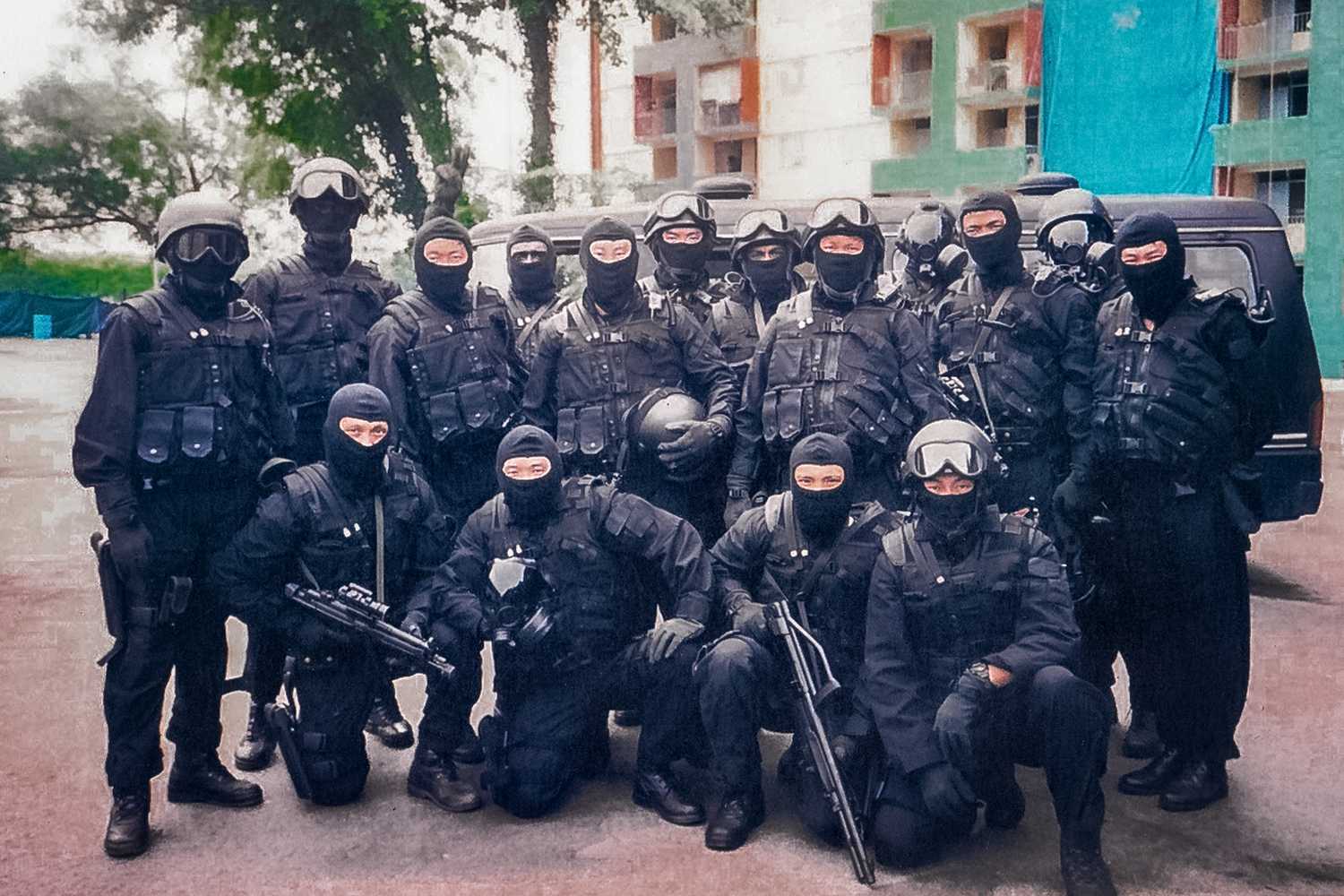 A group of people in black uniforms with headgear and balaclava