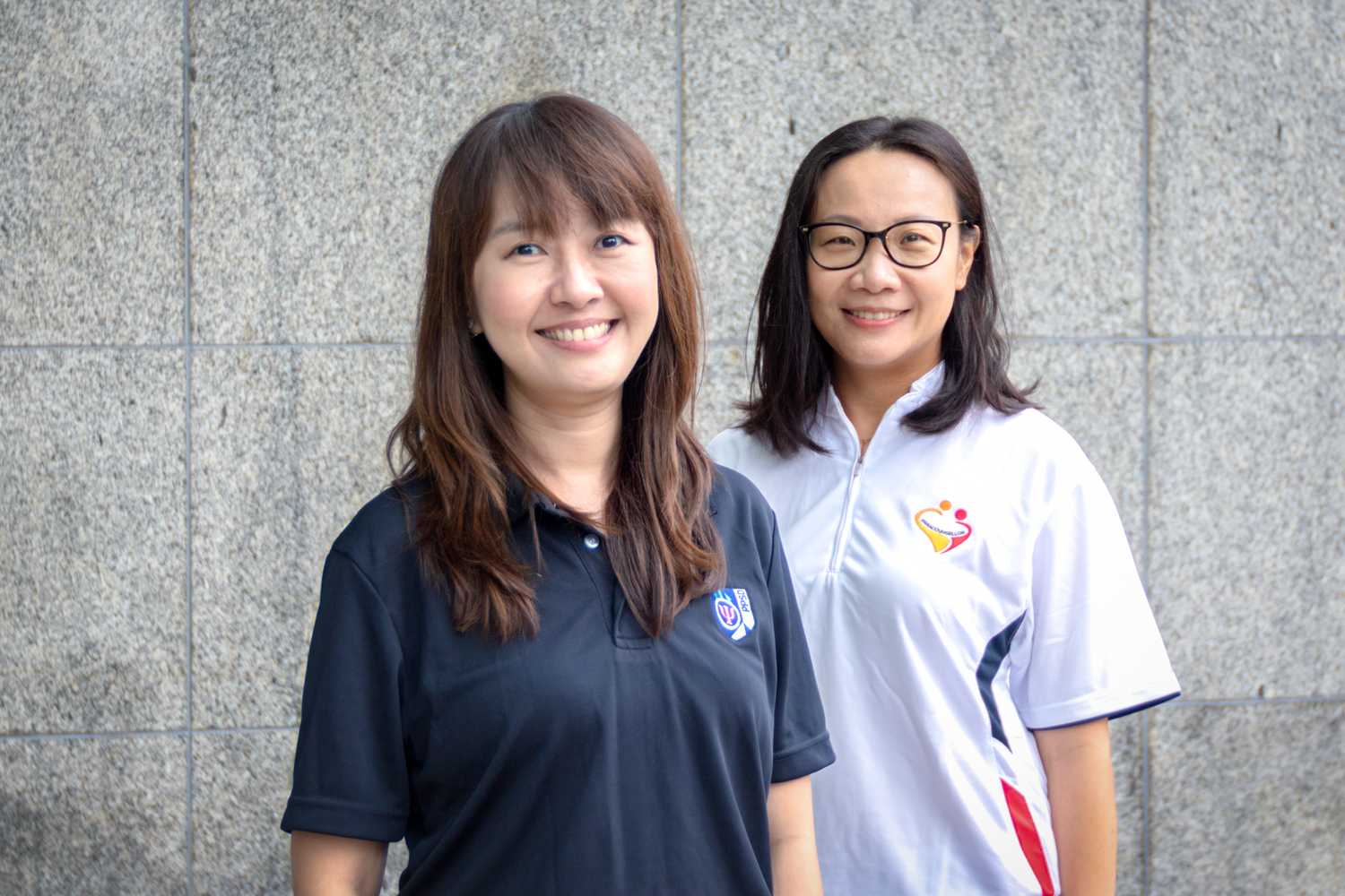 A profile shot with two women wearing plainclothes smiling and staring at the camera. PPSD Principal Psychologist Ms Ho Hui Fen is on the left while Deputy Chairperson of the Paracounsellor Committee DAC Tay Wee Li is on the right.