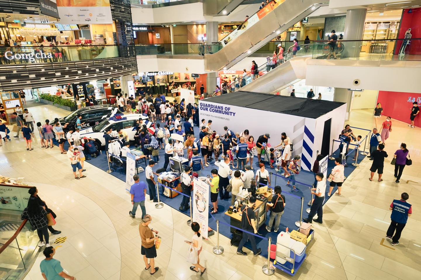 aerial shot of the event where a large crowd of people are gathering and visiting the event