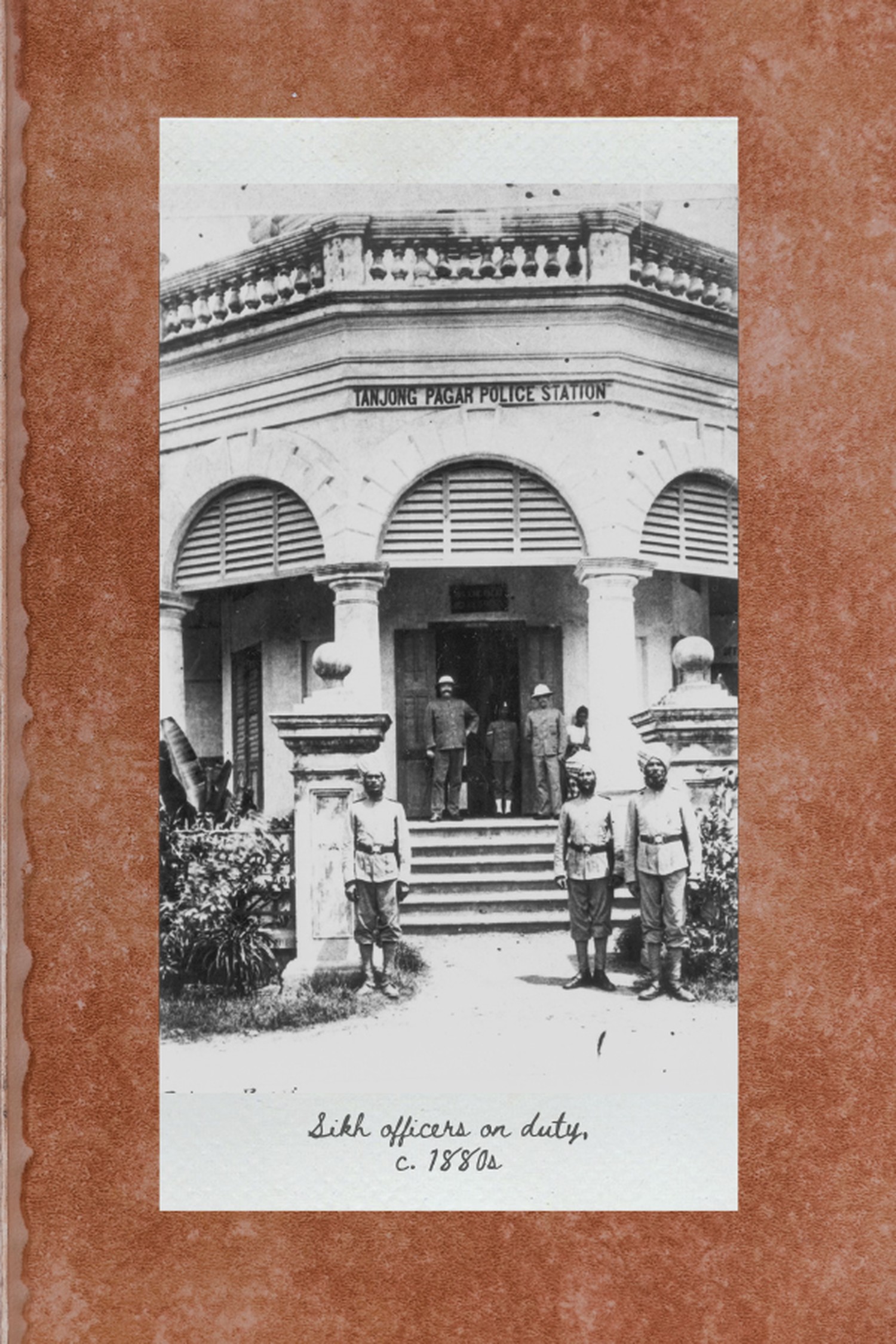 an old black and white photo of a sikh officers standing guard outside a colonial building