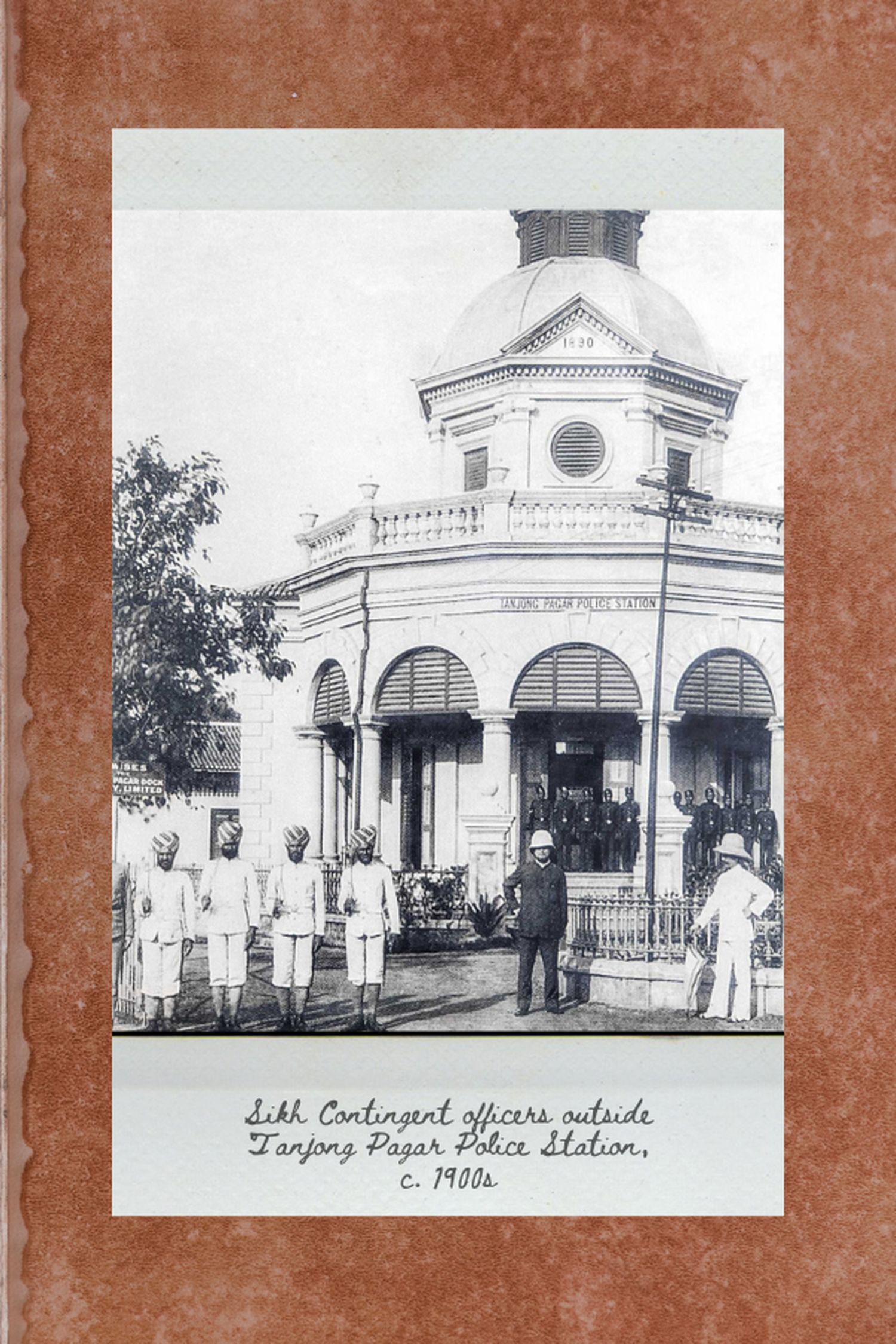 photo of the old tanjong pagar police station, which is a white colonial type building. Sikh officers are standing at the steps of the single storey building