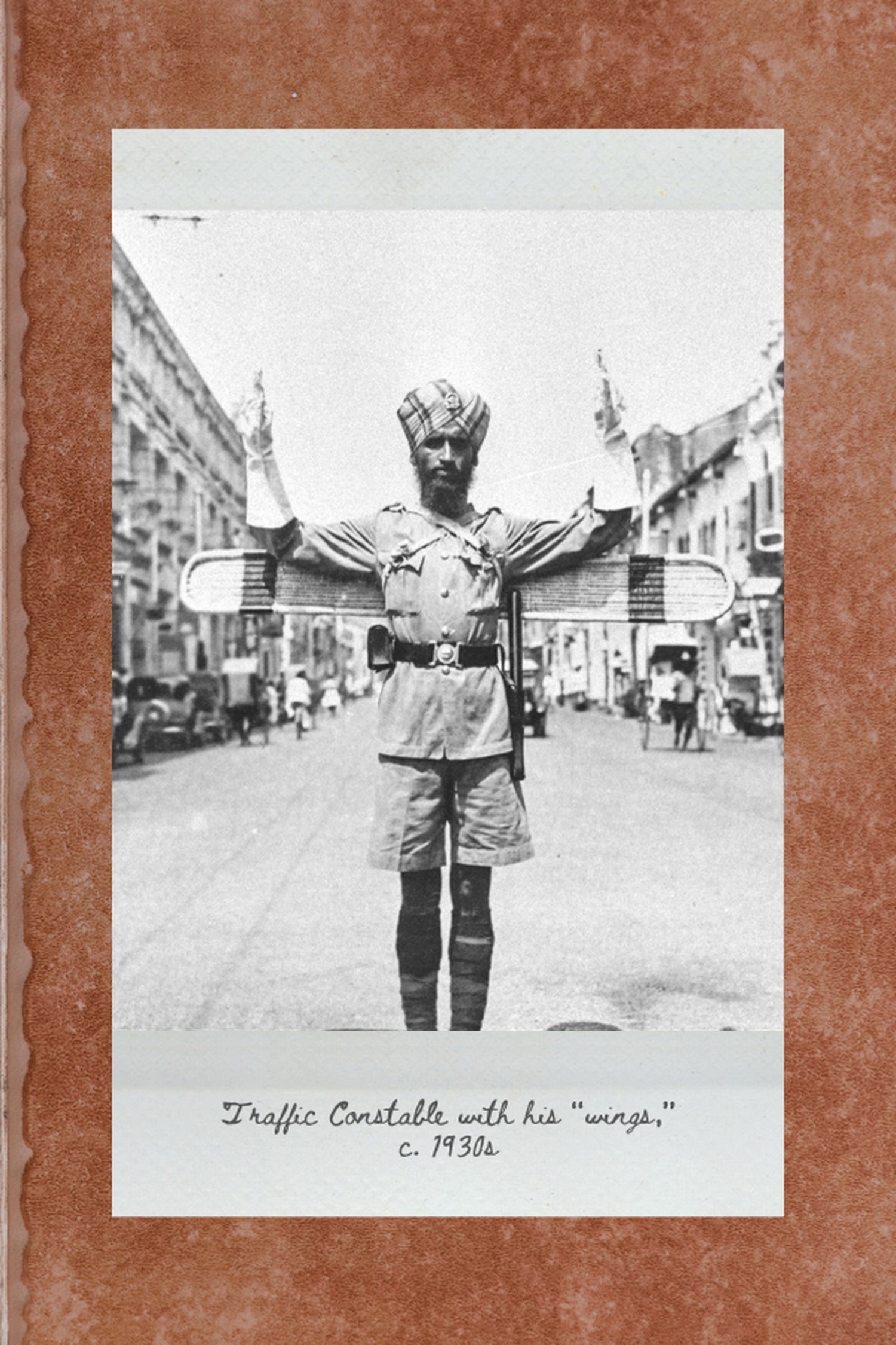 a sikh officer independently standing in the middle of a junction to control traffic, with wooden "wings" at the back of his uniform to indicate direction