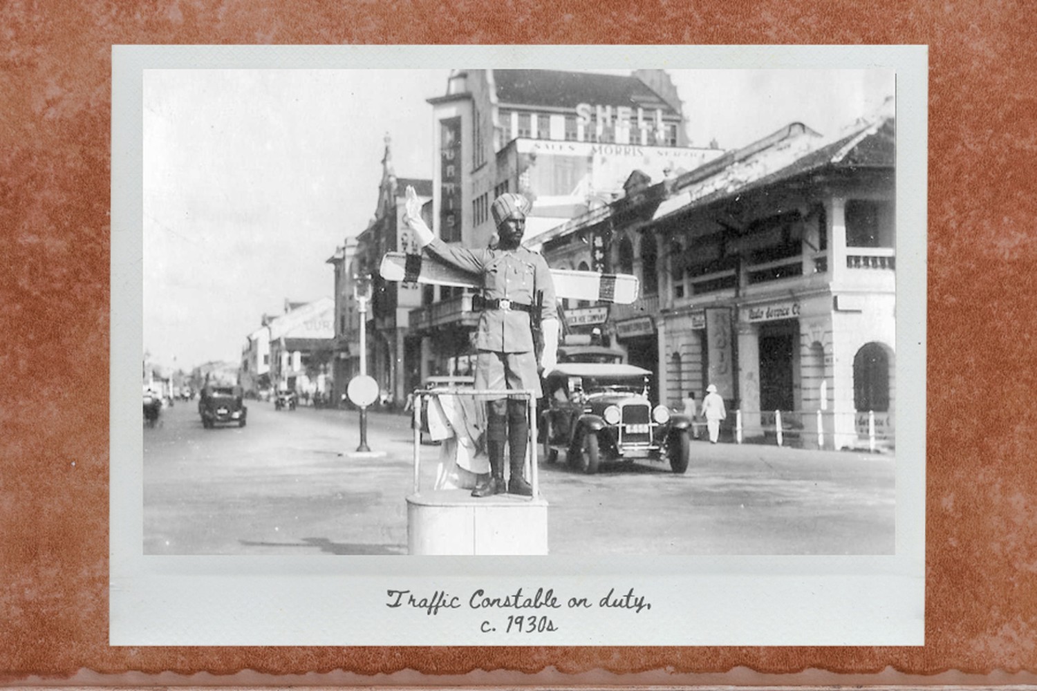 another sikh officer controlling traffic but pointing his white glove to the right of him (left of reader) 