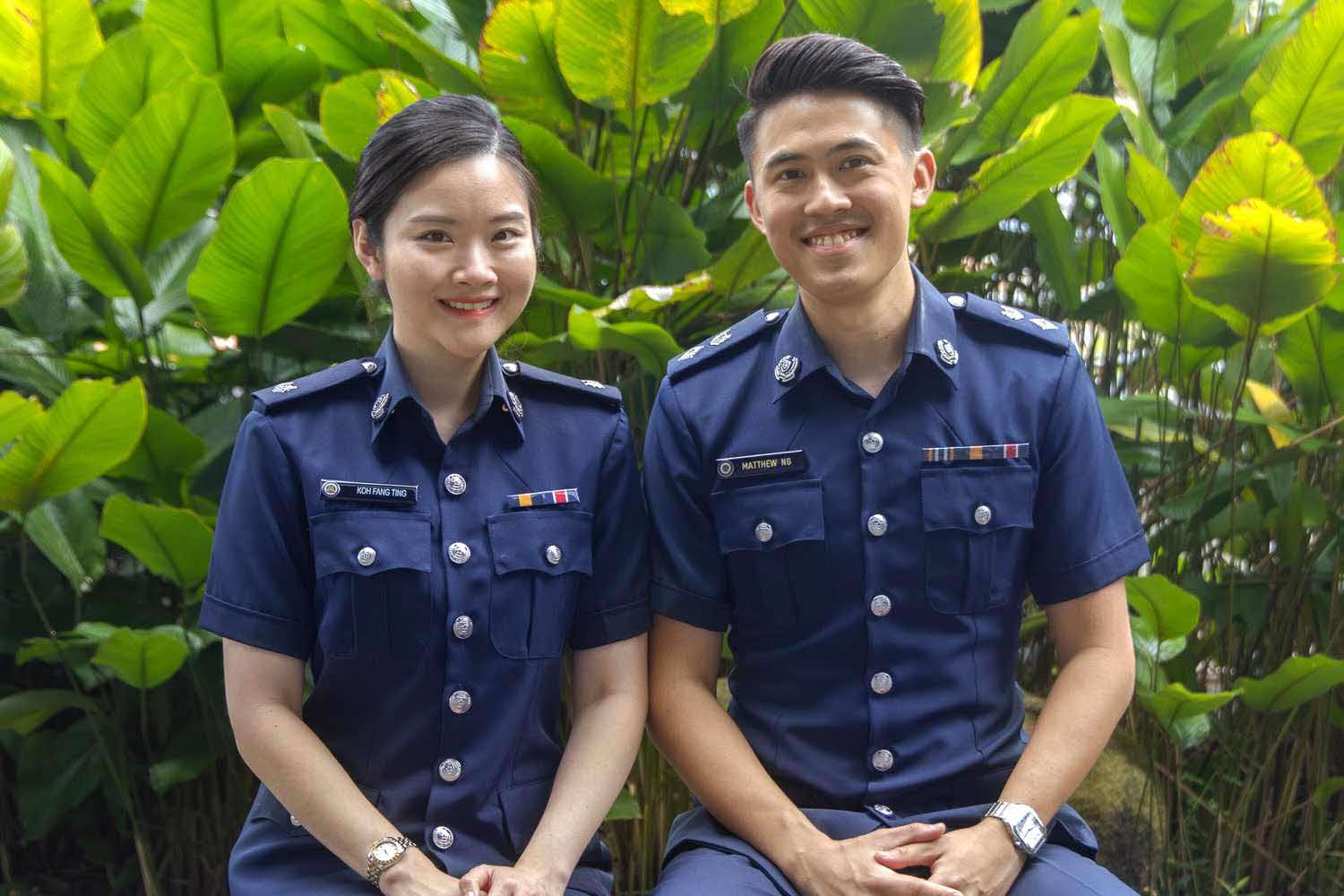 two officers sitting side by side at the garden, looking at the camera