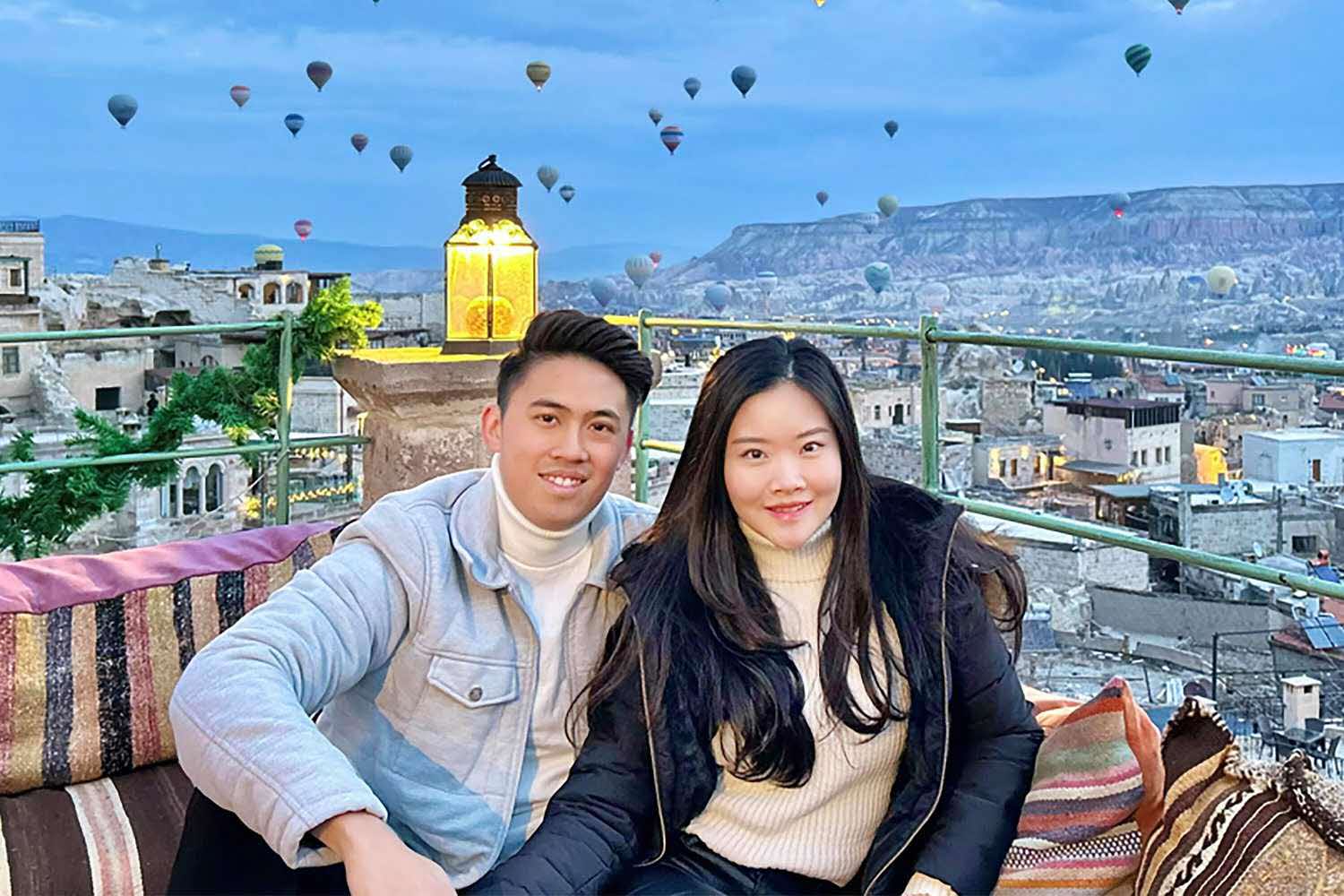 a couple on holiday at turkey, with hot air balloons