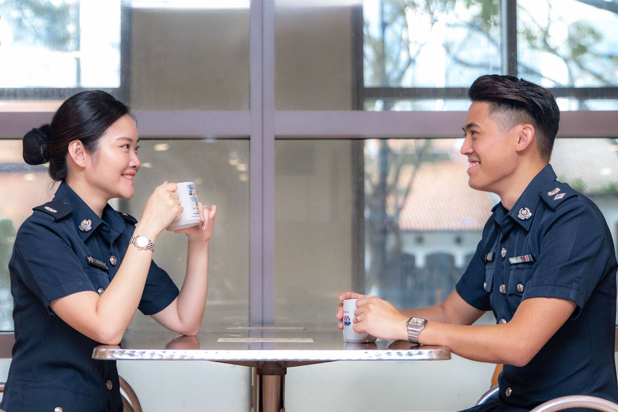 two officers chatting and drinking coffee at cafeteria