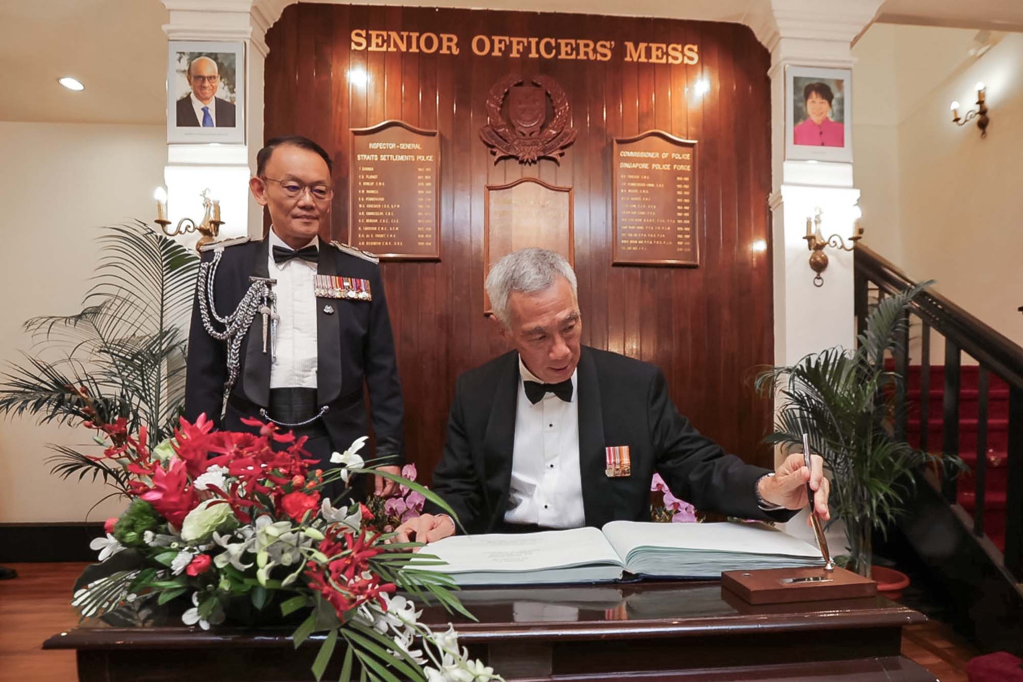PM Lee Hsien Loong signing the Visitors’ Book at SPOM
