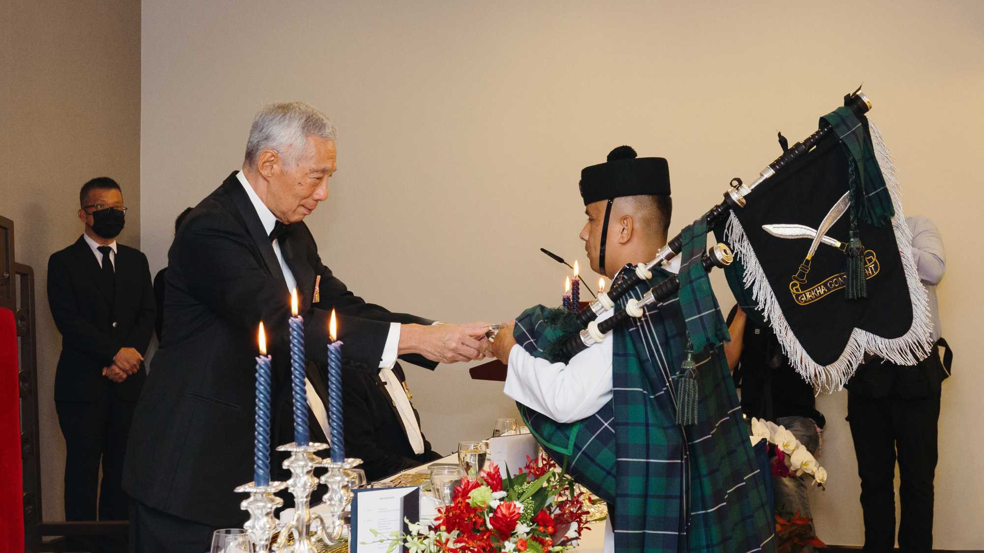 PM Lee Hsien Loong receiving a salute from the Piper Sergeant Major.