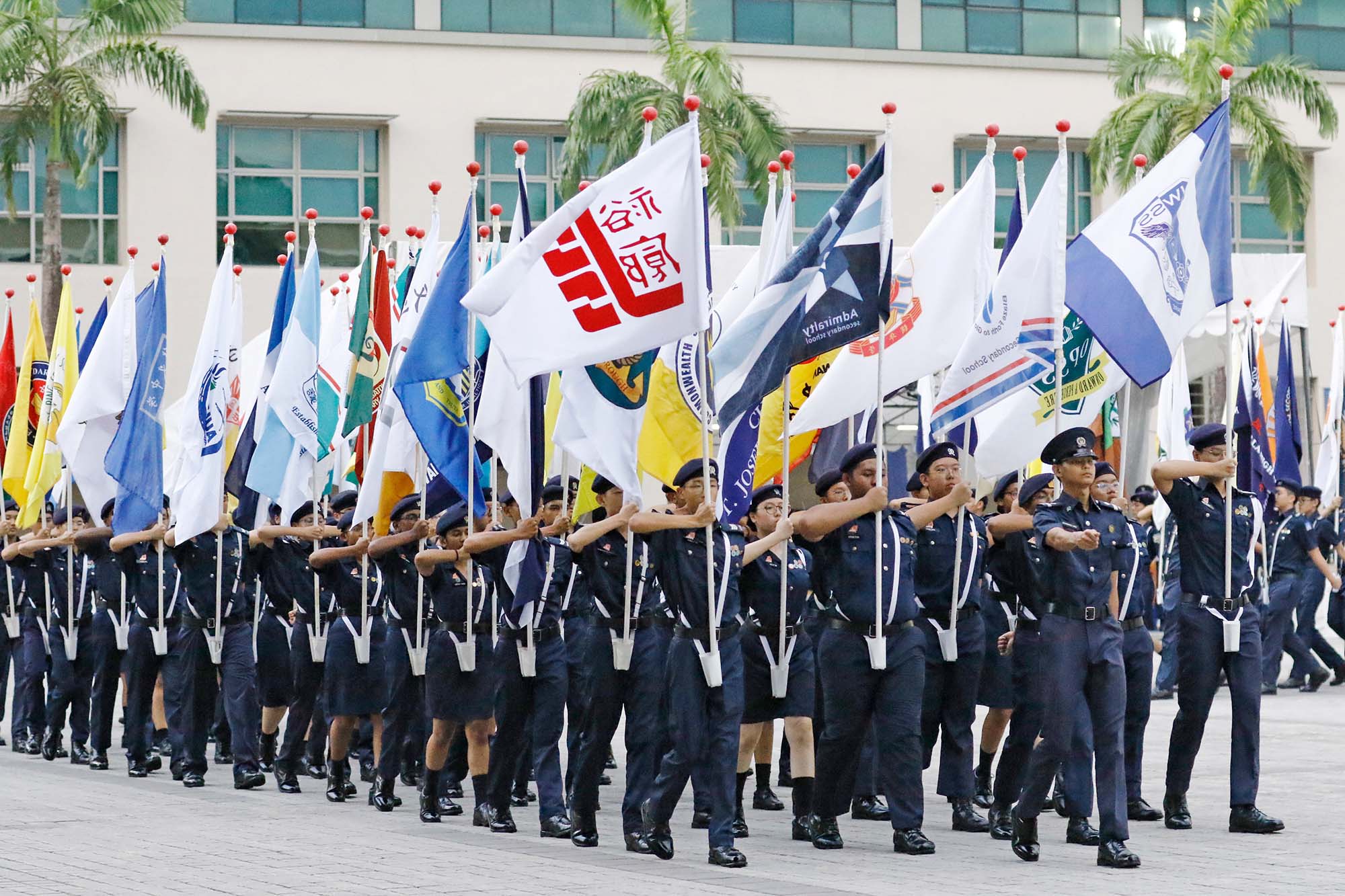 Cadets carrying their school flags for the march-past. PHOTO: Ryan Yeo