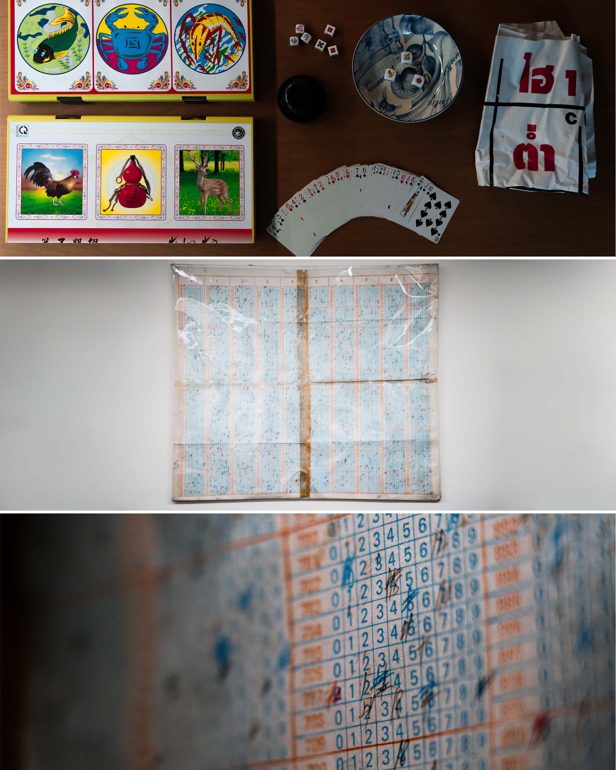 Gambling paraphernalia seized by Insp Lee and team: a Vietnamese variation of the Chinese "Hoo Hey How" dice game (top) and a 10,000-combination physical chart (middle and bottom) used for illegal lottery bets in the 1990s. PHOTO: Soh Ying Jie
