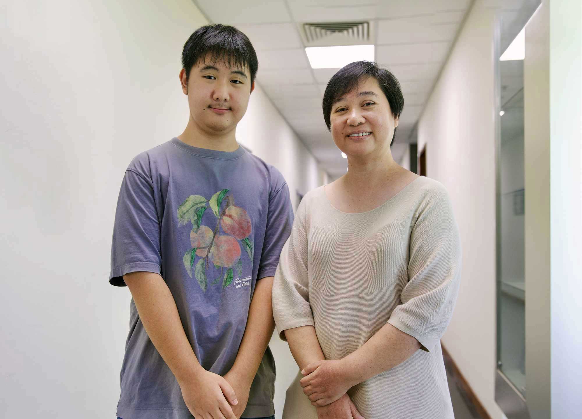 two members of the public standing together and posing for the photo
