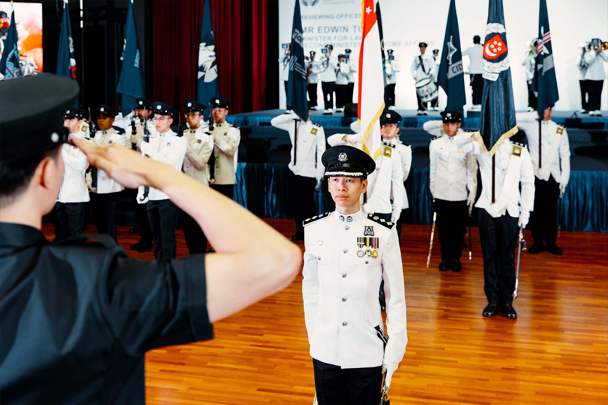 photo of commander standing infront of a stand-in representative of CP, during rehearsal