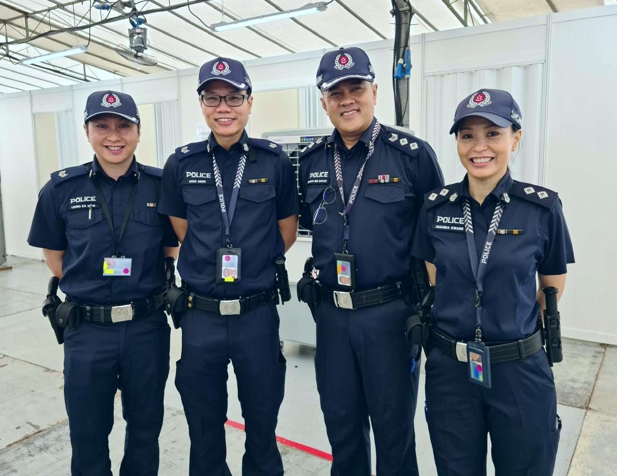 bahar together with his officers, standing wearing uniform, under a white tentage