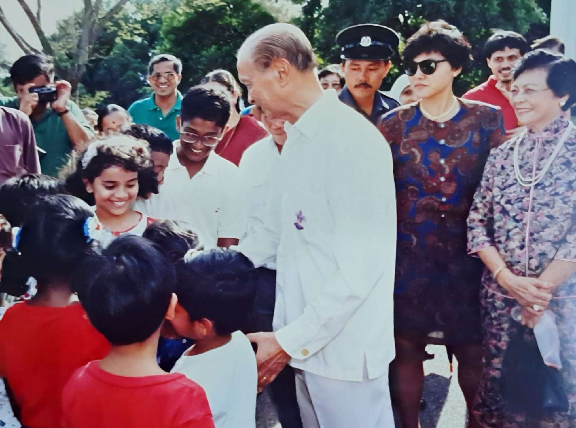 wee kim wee and his wife at the istana open house surrounded by children
