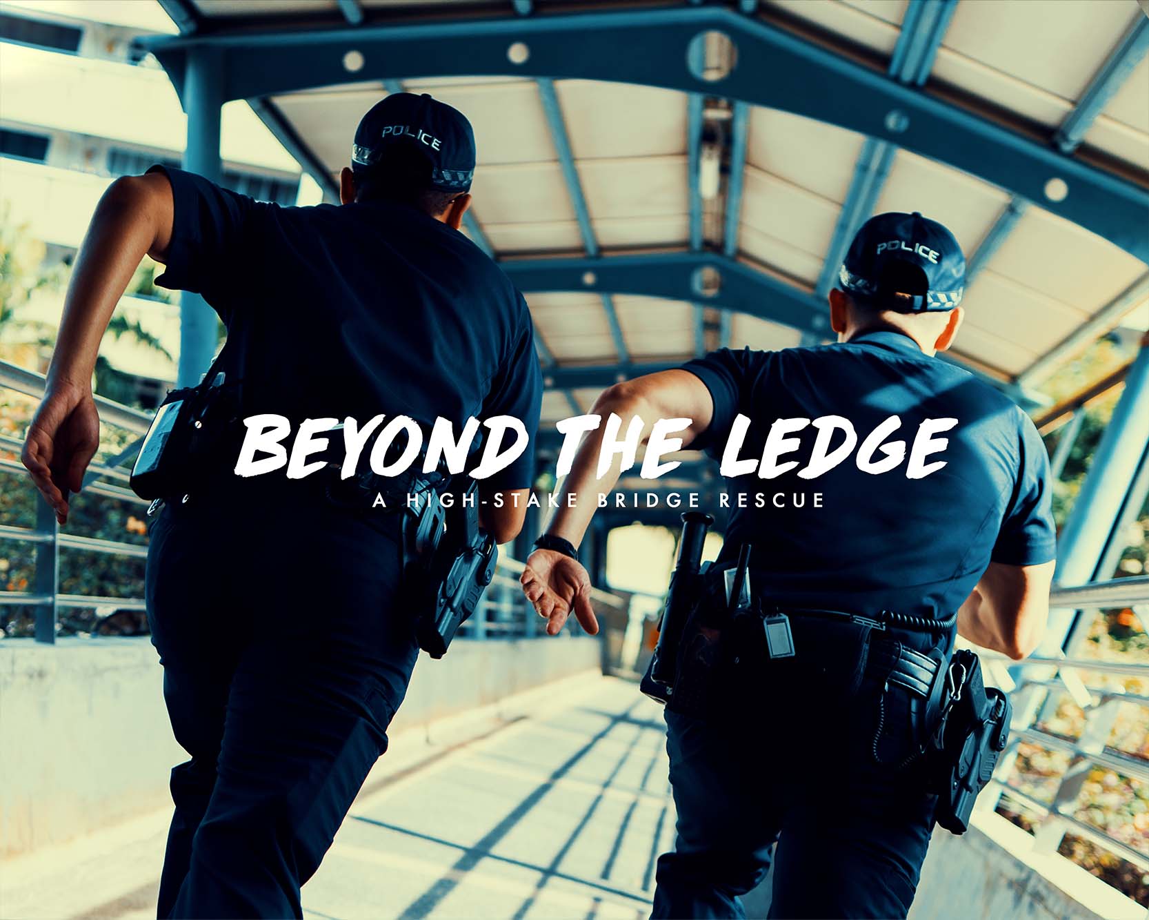 two officers running away from camera on an overhead bridge