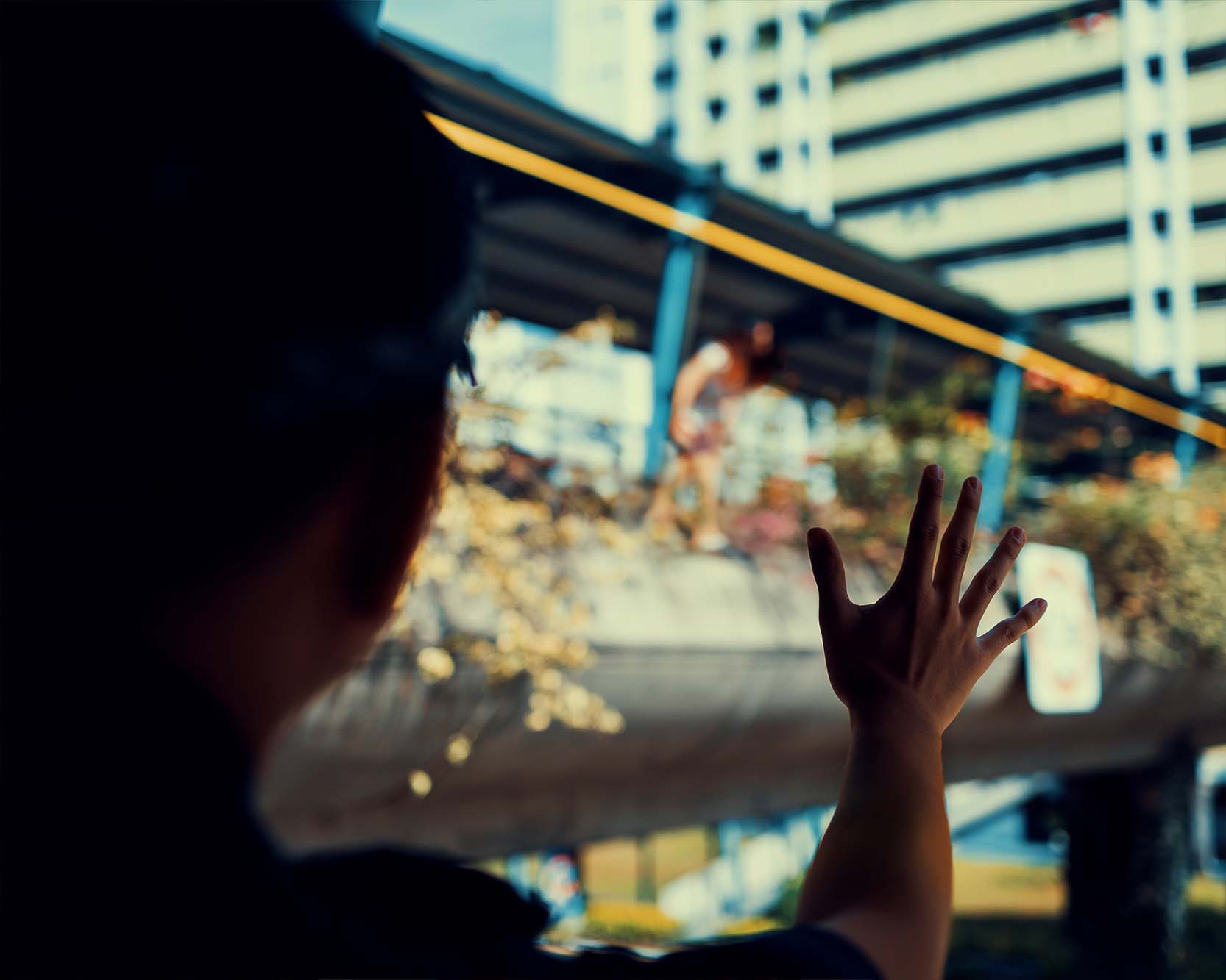 an officer shouting at a woman who is seen standing outside of the overhead bridge and about to jump