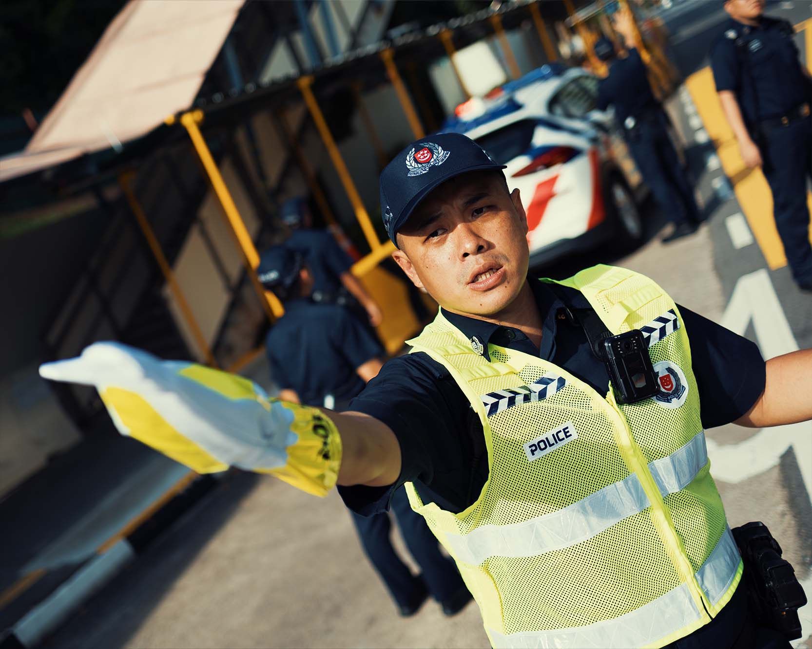 officer with police vest and traffic gloves controlling traffic