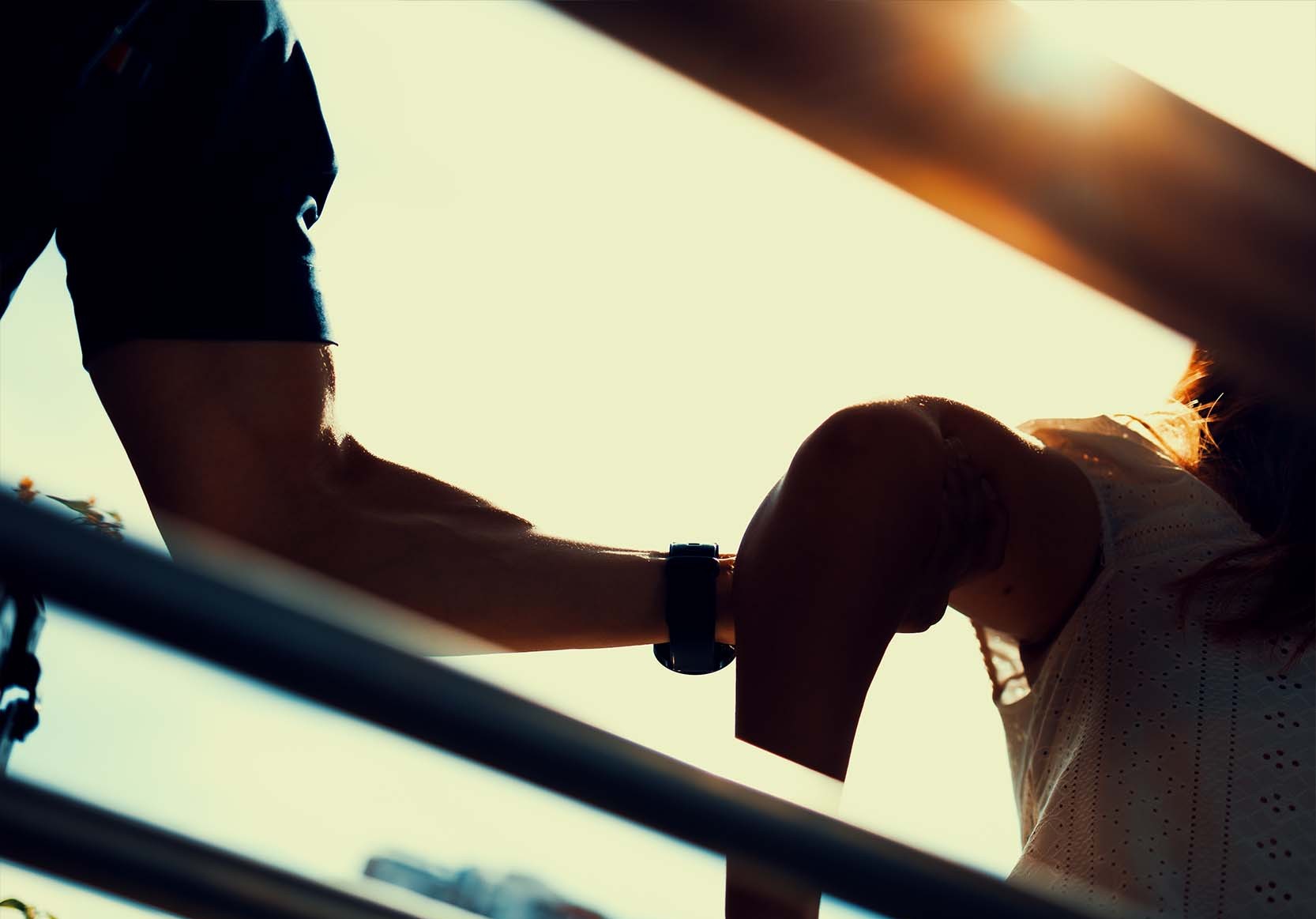 a silhouette of an officer grabbing onto a woman's bicep