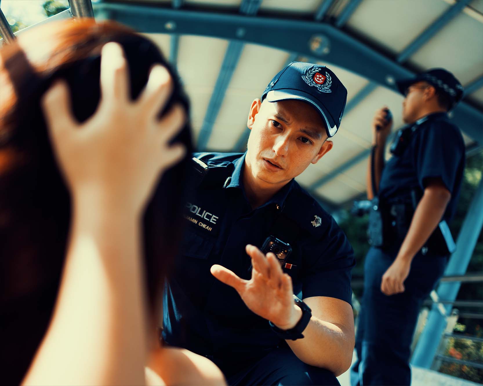 officer seen squatting and comforting the woman who is seated on the floor